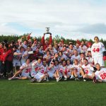 Head Coach Tim Murdoch hoists the Baggataway Cup, as the Redmen celebrate their title. (Kevin Caplice)